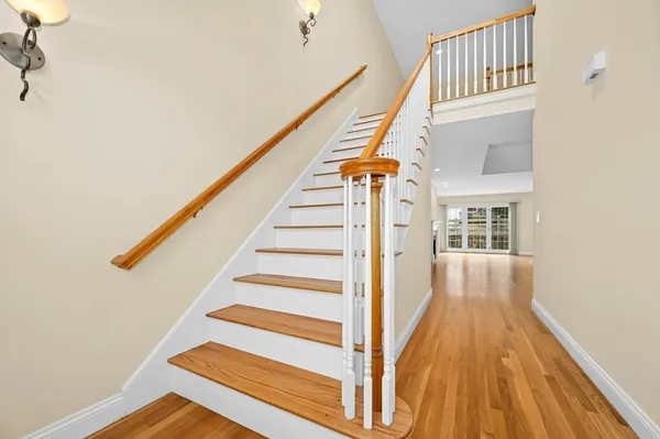 a view of entryway with wooden floor and stairs