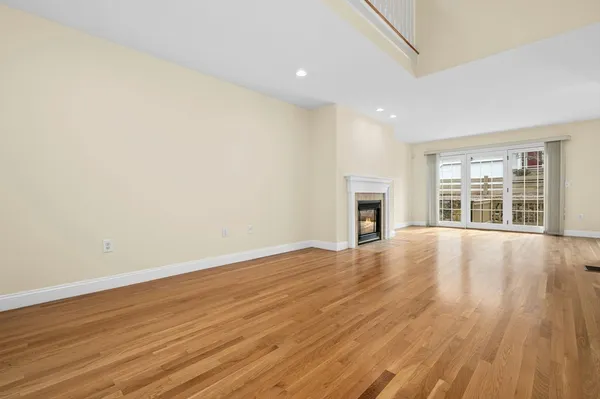 wooden floor in an empty room with a fireplace