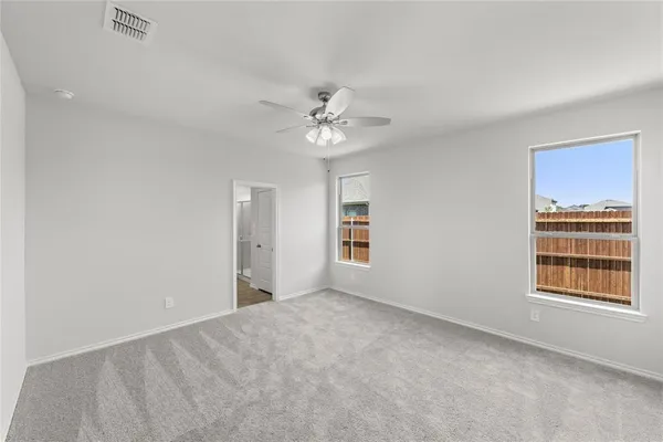 a view of small space with wooden floor and white walls