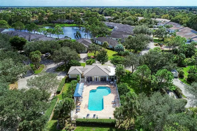 a view of a house with swimming pool and sitting area