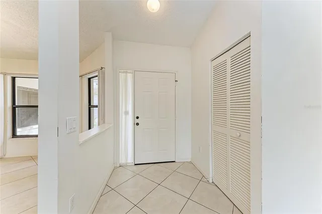 a view of a hallway with closet and bathroom