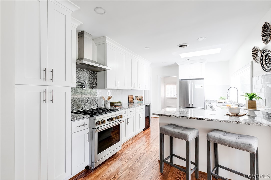 7607 Cherokee Road Richmond, VA 23225 - Photo 35 of 37 a kitchen with stainless steel appliances granite countertop a stove a sink dishwasher and a refrigerator with white cabinets