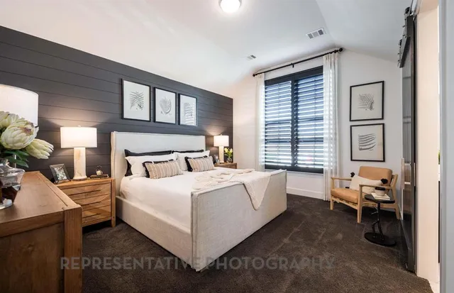 a bed room with a bed and a chair