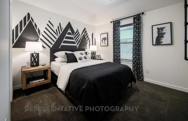a bedroom with a bed and a night stand