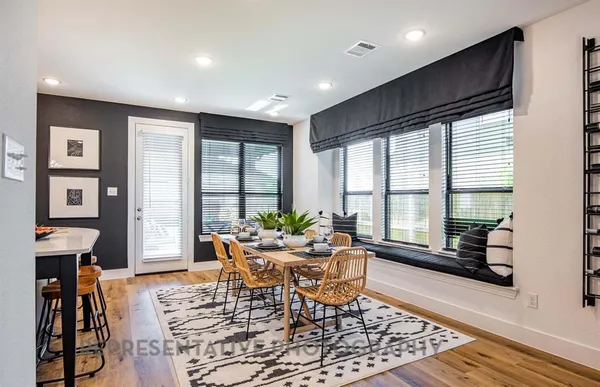 a dining room with furniture and wooden floor