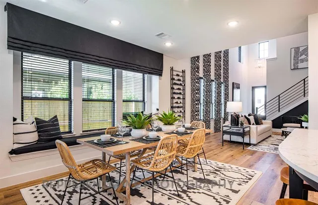 a living room with furniture and floor to ceiling windows