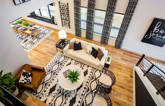 a picture of a living room with furniture and wooden floor