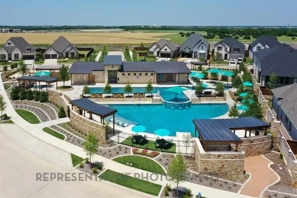 an aerial view of a house with a garden and outdoor seating