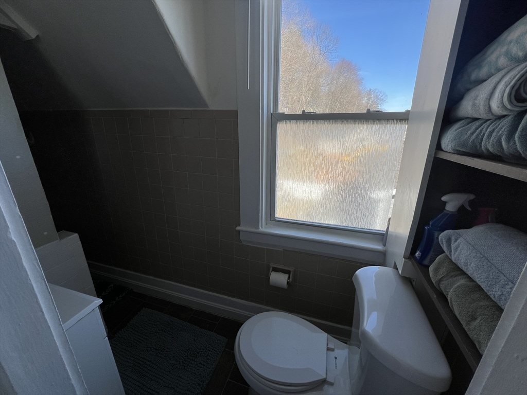272 Front Street, Unit 5 Manchester, NH 03102 - Photo 12 of 19 a bathroom with a toilet a sink and a window