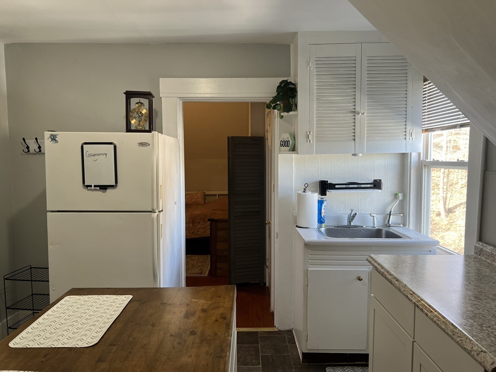 272 Front Street, Unit 5 Manchester, NH 03102 - Photo 3 of 19 a kitchen with a refrigerator and a sink
