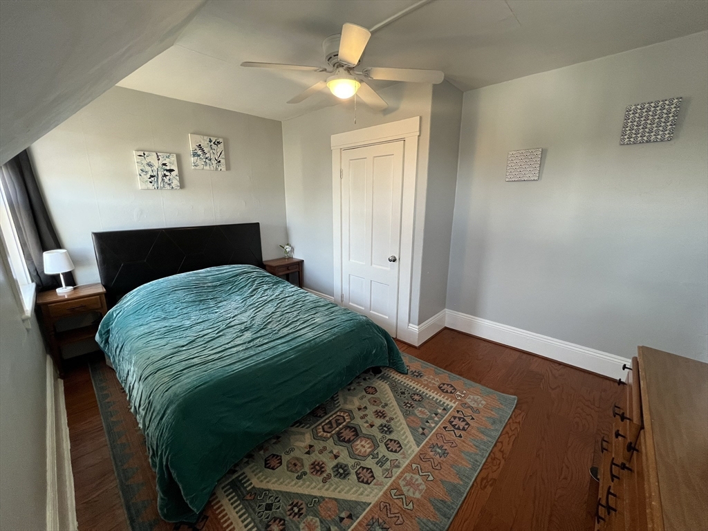272 Front Street, Unit 5 Manchester, NH 03102 - Photo 8 of 19 a bedroom with a bed and a lamp on dresser