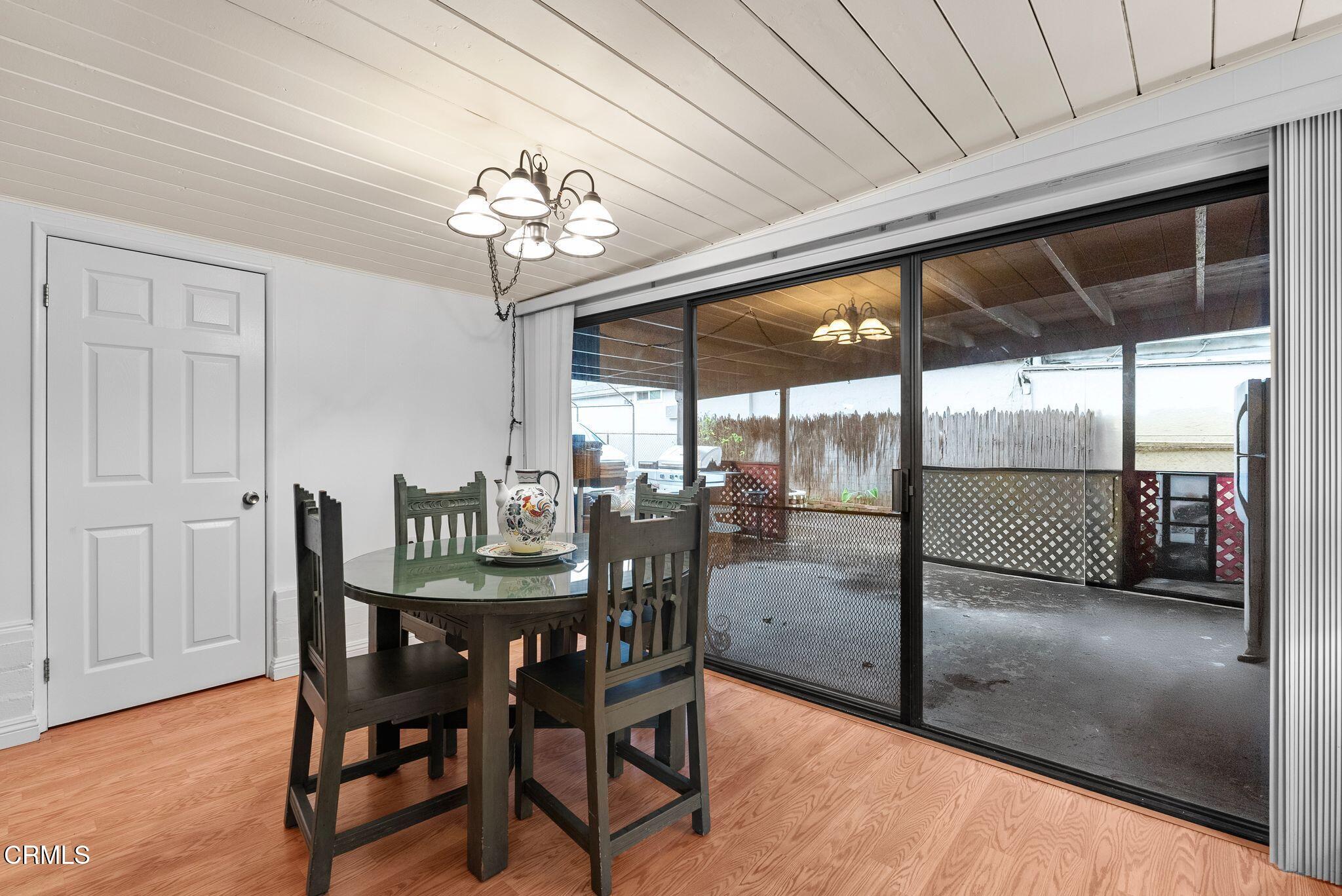 2102 North Eastern Avenue Los Angeles, CA 90032 - Photo 12 of 28 a dining room with furniture a chandelier and window