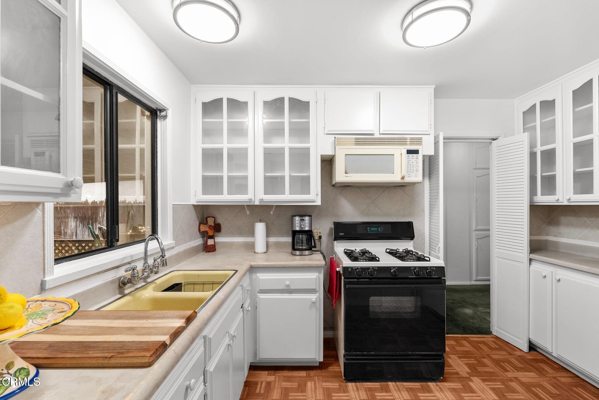 2102 North Eastern Avenue Los Angeles, CA 90032 - Photo 13 of 28 a kitchen with a stove a sink and a cabinets