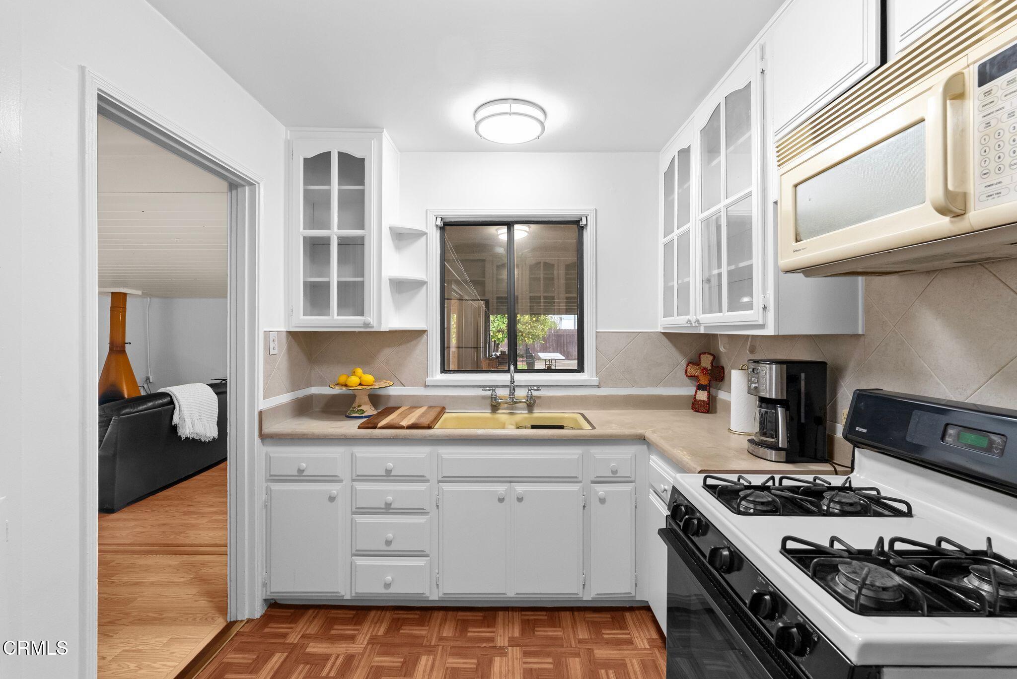 2102 North Eastern Avenue Los Angeles, CA 90032 - Photo 14 of 28 a kitchen with a stove a sink and cabinets