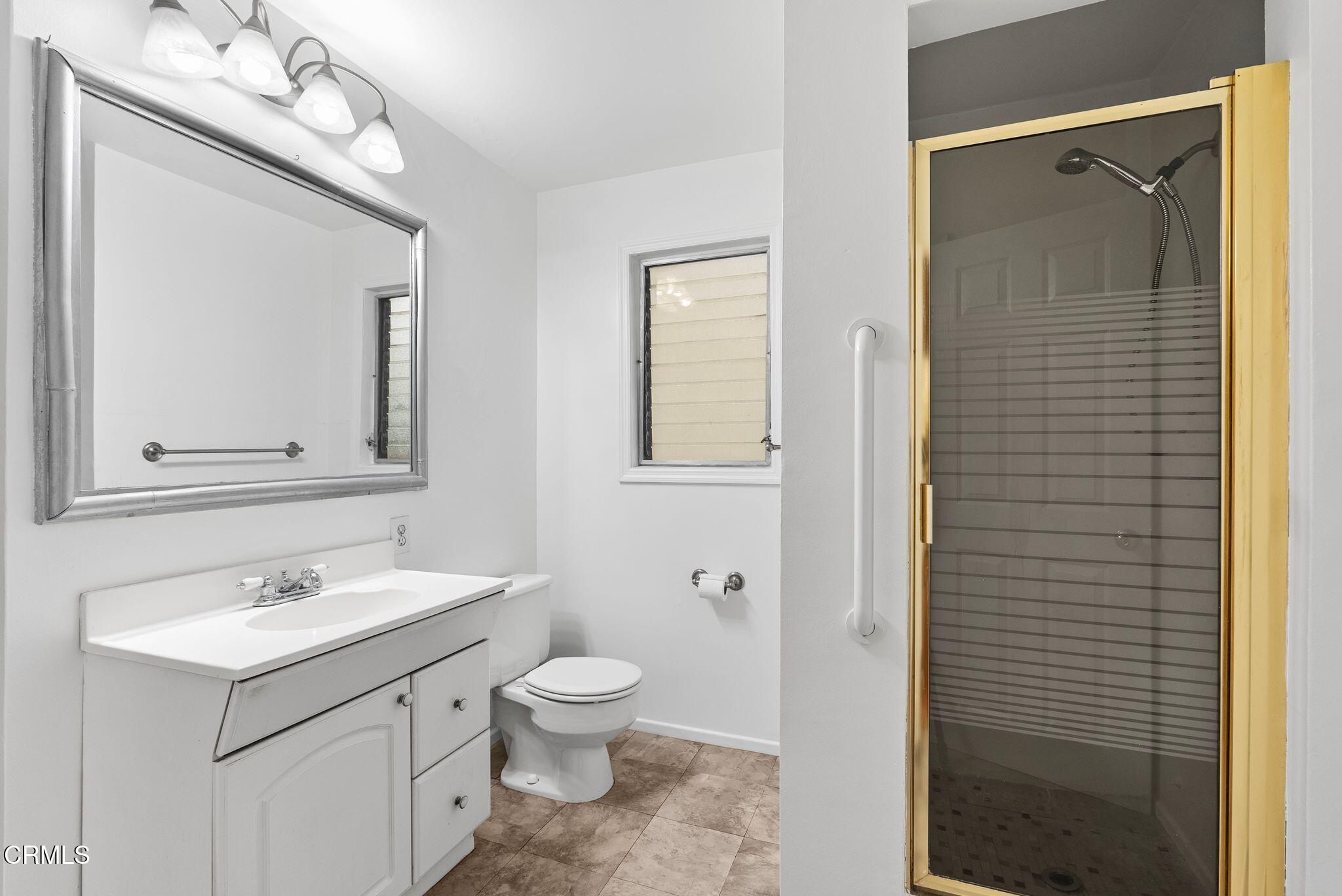 2102 North Eastern Avenue Los Angeles, CA 90032 - Photo 16 of 28 a bathroom with a toilet sink and mirror