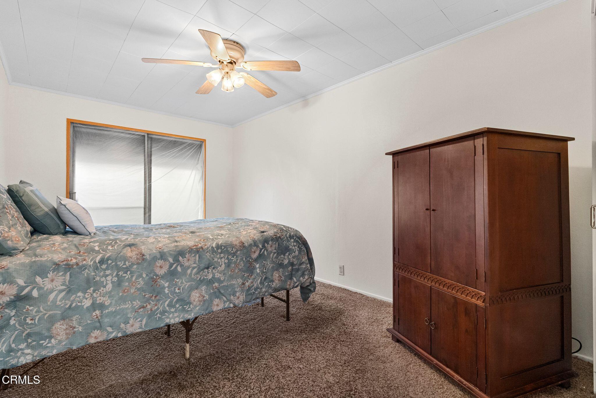 2102 North Eastern Avenue Los Angeles, CA 90032 - Photo 17 of 28 a bed room with a bed and a ceiling fan