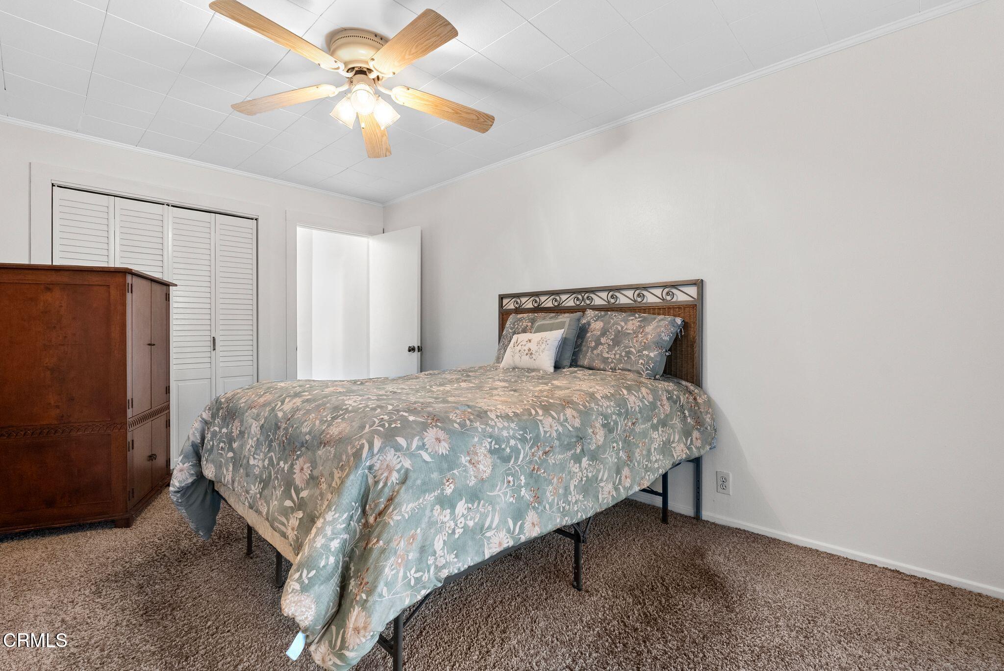2102 North Eastern Avenue Los Angeles, CA 90032 - Photo 18 of 28 a bedroom with a bed and a refrigerator