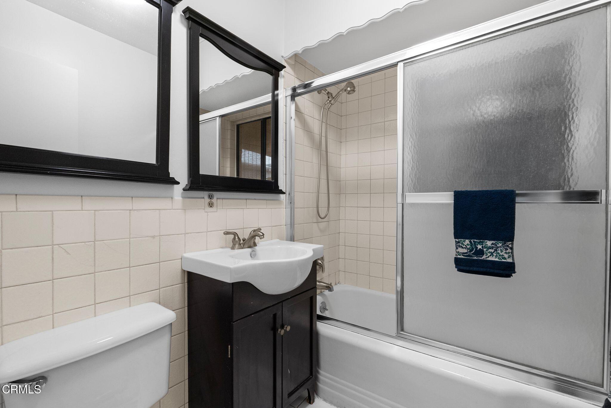2102 North Eastern Avenue Los Angeles, CA 90032 - Photo 19 of 28 a bathroom with a sink a toilet and a mirror