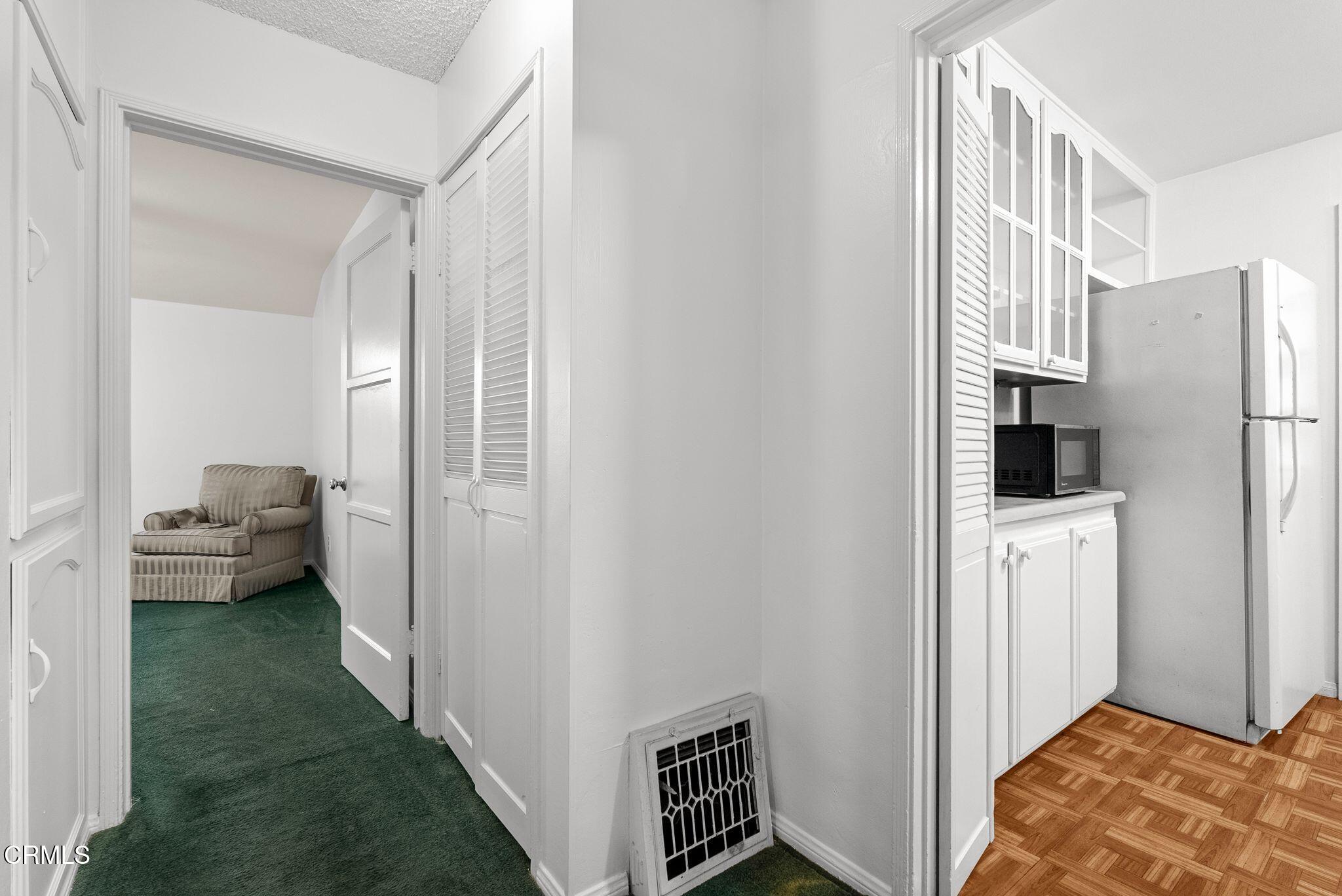 2102 North Eastern Avenue Los Angeles, CA 90032 - Photo 21 of 28 a view of a bedroom with a bed and wooden floor