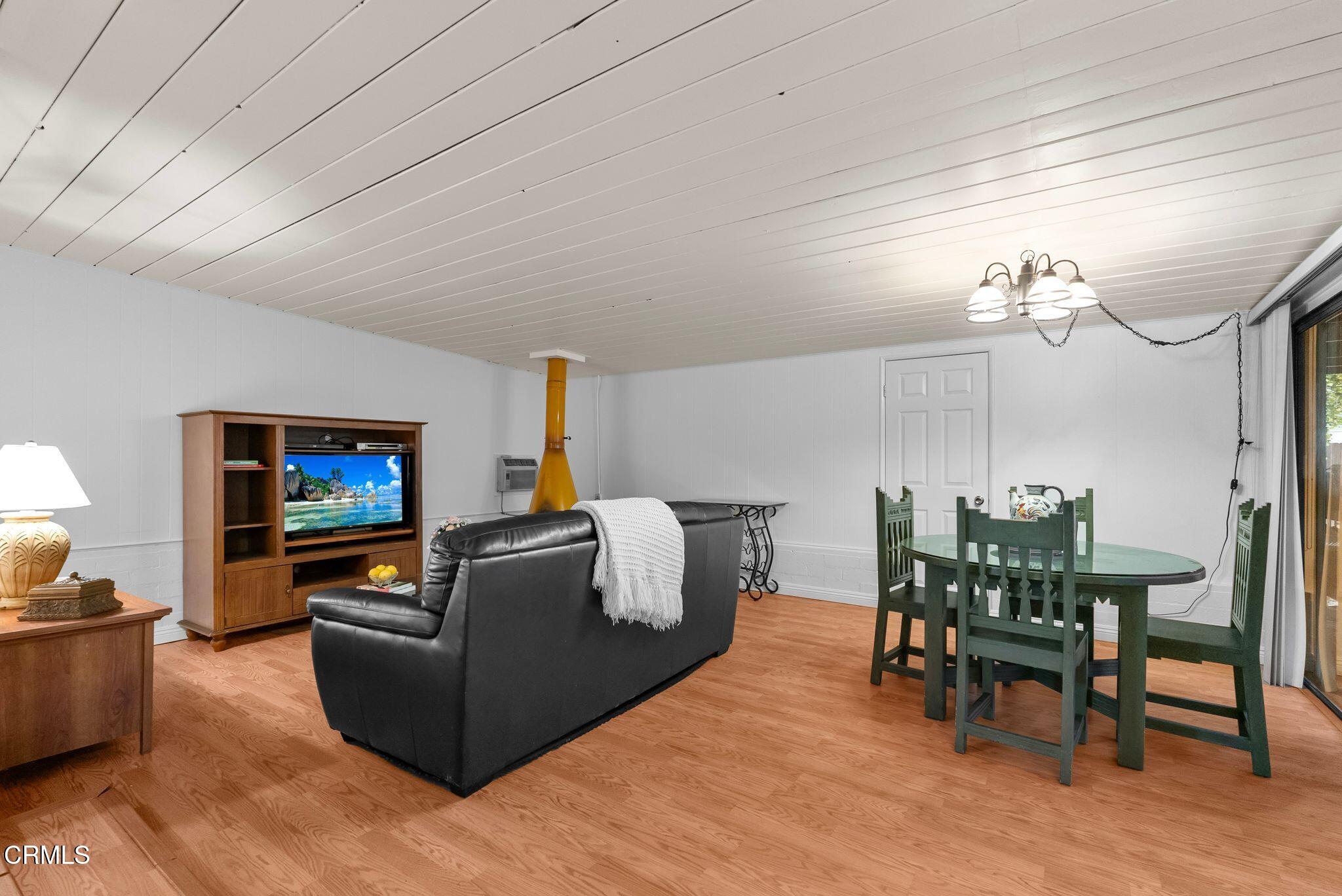 2102 North Eastern Avenue Los Angeles, CA 90032 - Photo 9 of 28 a living room with furniture a dining table and a piano