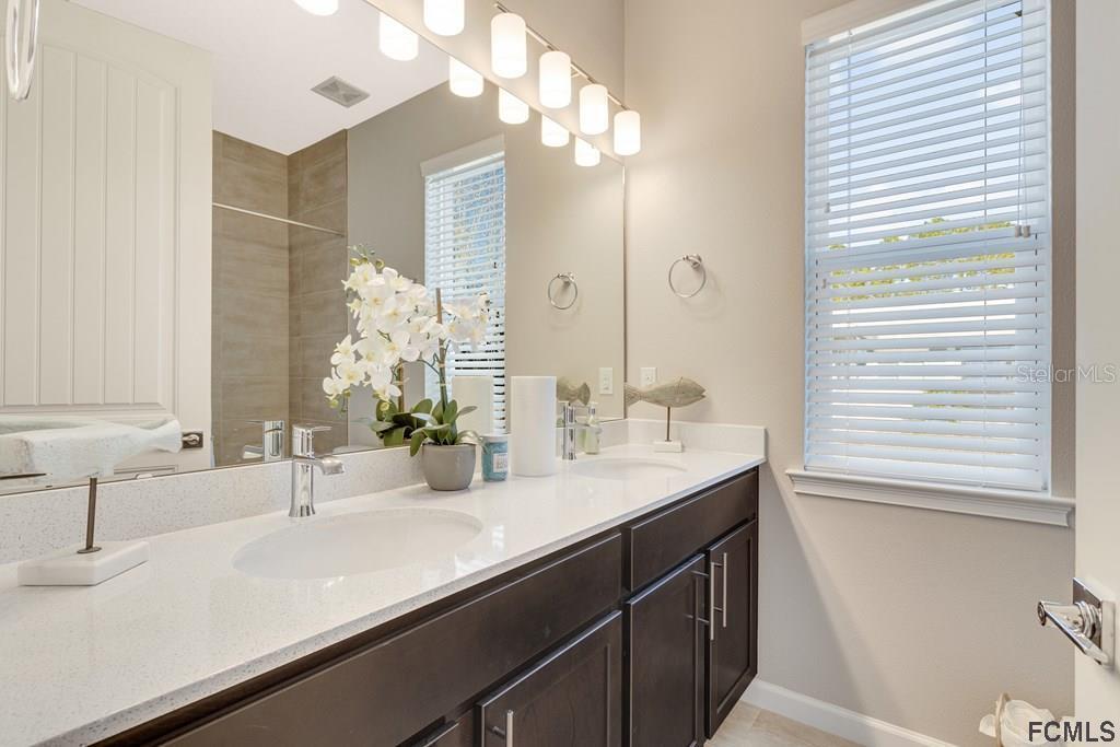 584 Octavius Road Southwest Palm Bay, FL 32908 - Photo 11 of 30 a bathroom with a sink and a mirror