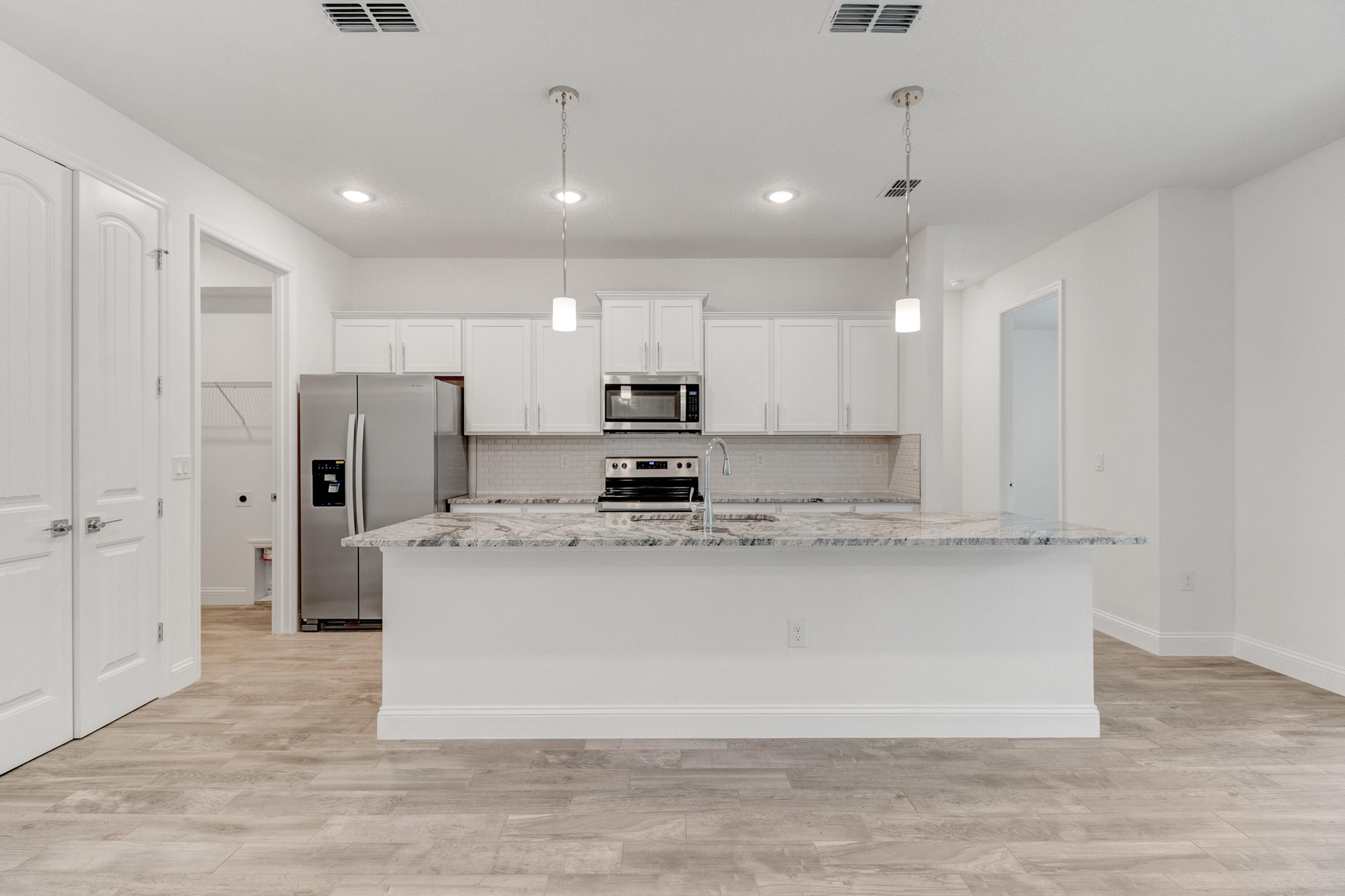 584 Octavius Road Southwest Palm Bay, FL 32908 - Photo 21 of 30 a large kitchen with stainless steel appliances granite countertop a stove a refrigerator a sink and a oven
