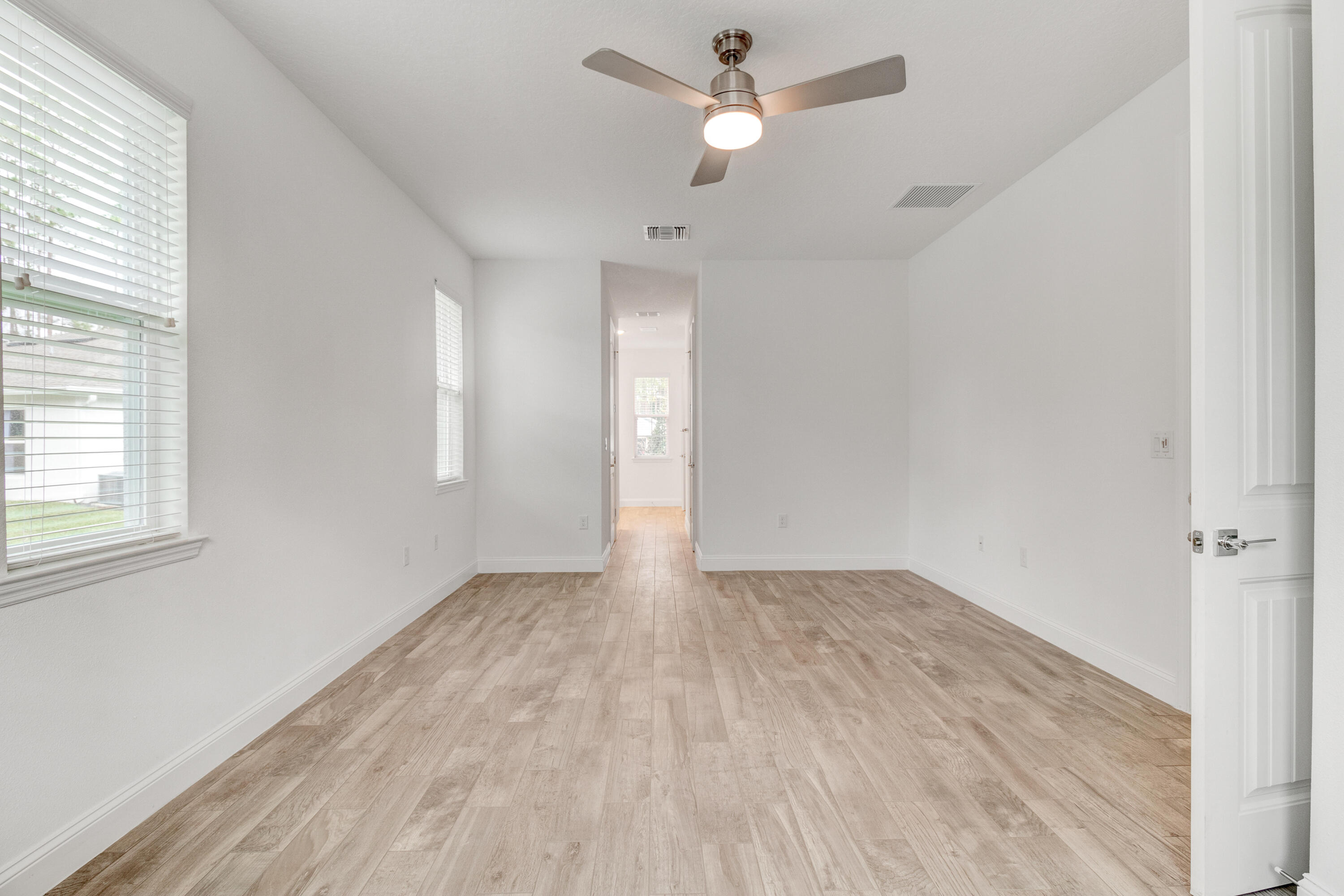 584 Octavius Road Southwest Palm Bay, FL 32908 - Photo 25 of 30 wooden floor in an empty room with a window