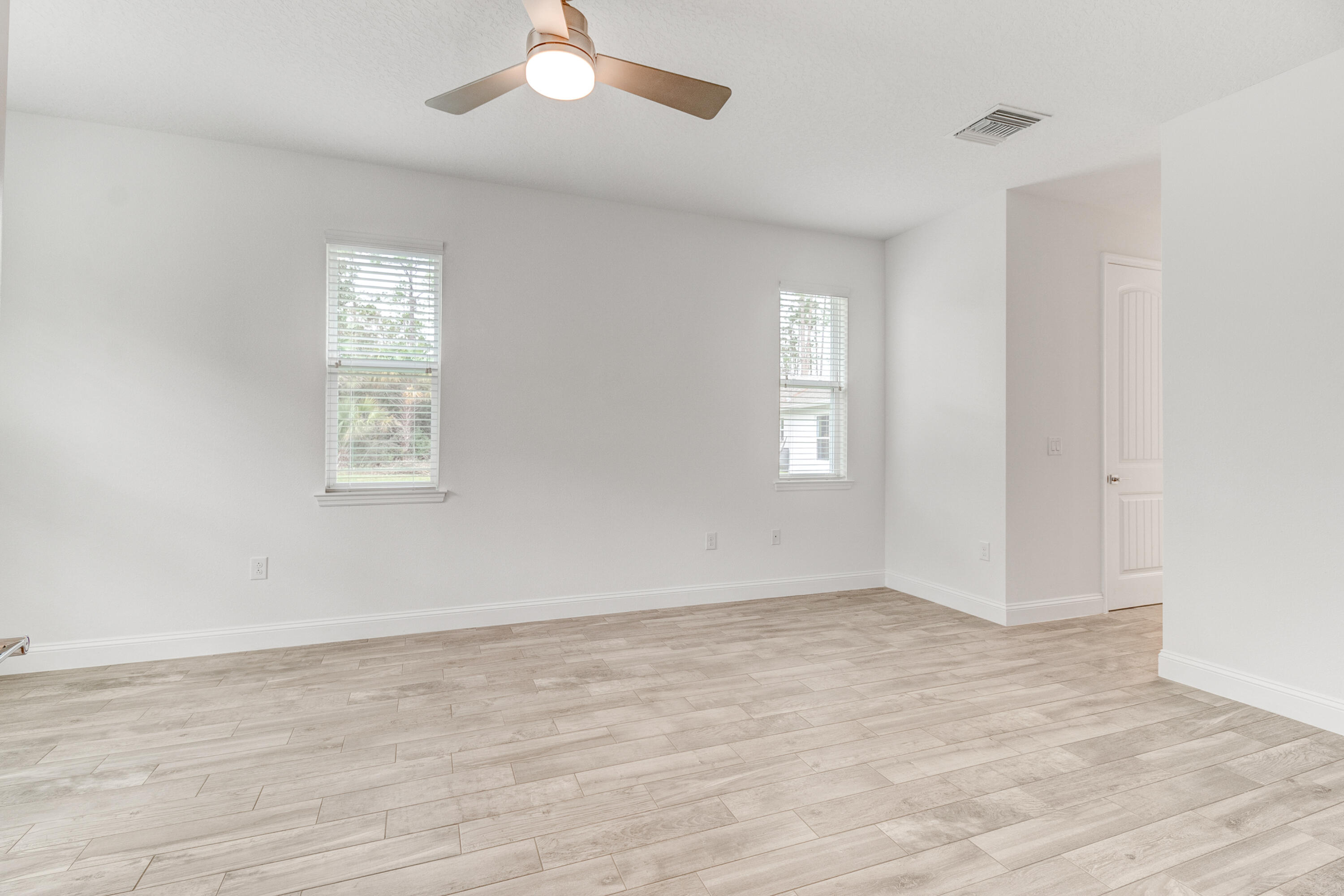 584 Octavius Road Southwest Palm Bay, FL 32908 - Photo 28 of 30 wooden floor in an empty room with a window