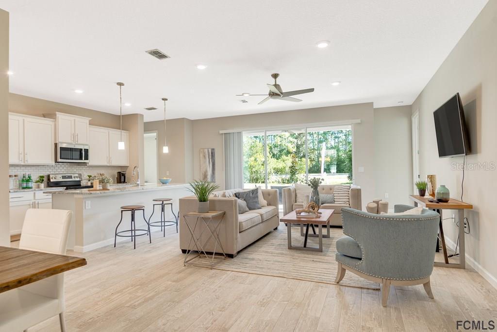 584 Octavius Road Southwest Palm Bay, FL 32908 - Photo 3 of 30 a living room with furniture and a flat screen tv