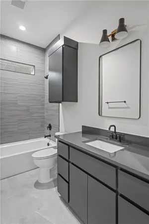 a bathroom with a toilet sink and bathtub