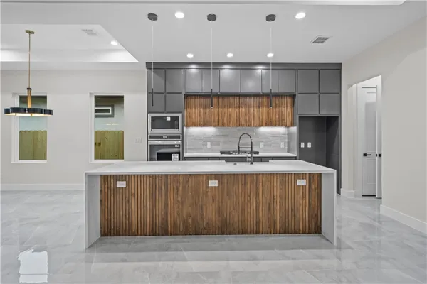 a kitchen with a sink and cabinets