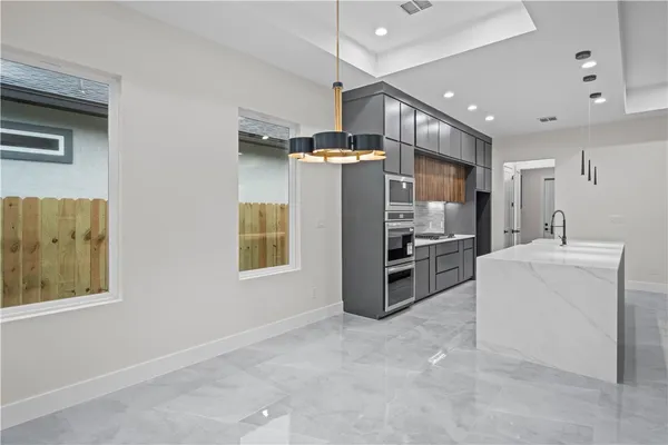 a kitchen with refrigerator and cabinets