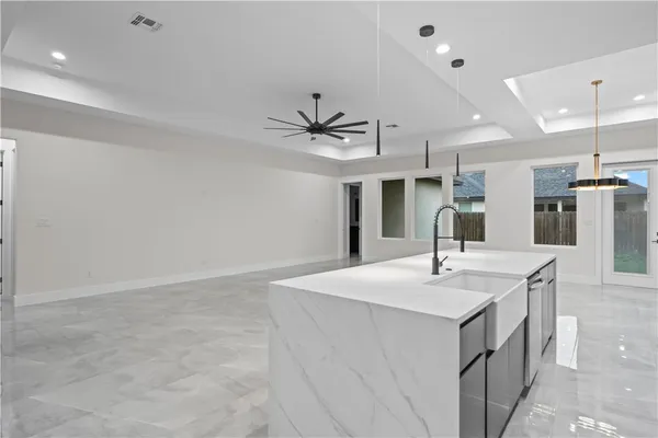 a view of kitchen with sink microwave and refrigerator