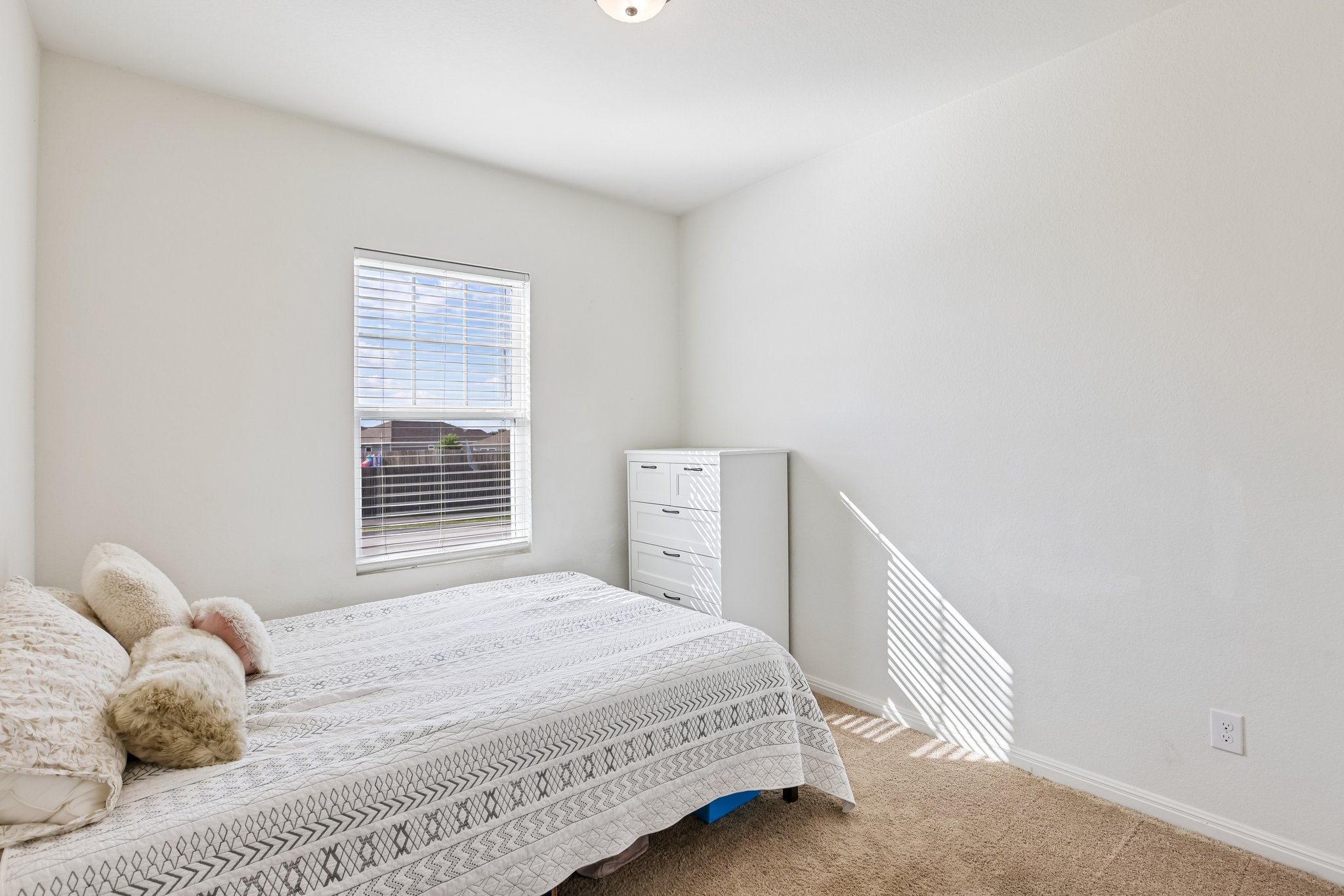 19105 Mike Mansfield Road Manor, TX 78653 - Photo 20 of 28 a bedroom with a bed and a window