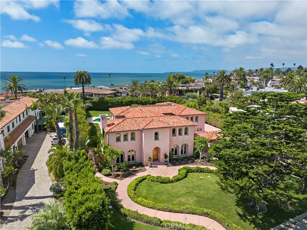 an aerial view of a house with swimming pool outdoor seating and yard