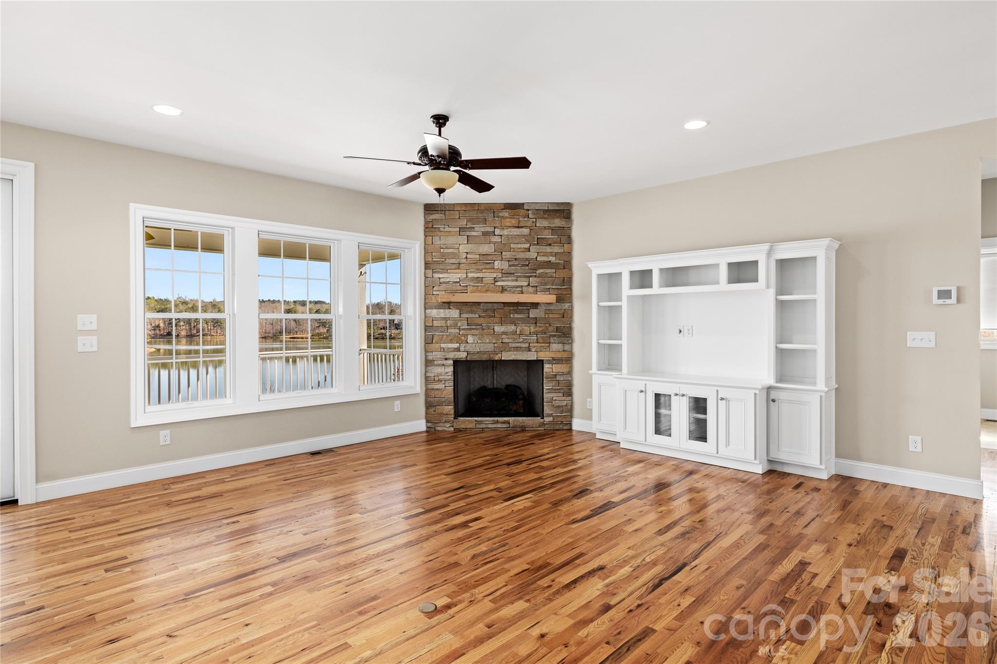 490 Mapleton Lane Columbus, NC 28722 - Photo 12 of 42 a view of a livingroom with a fireplace wooden floor and chandelier