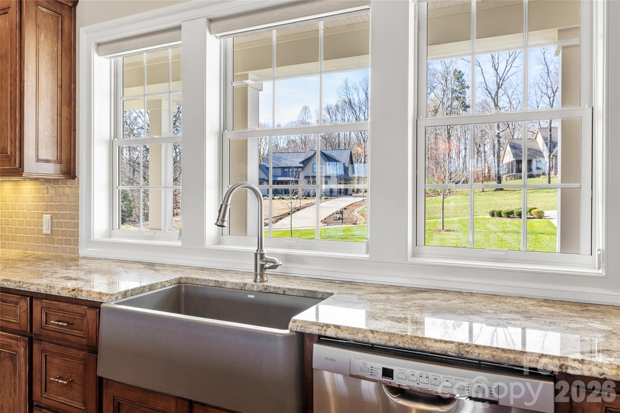 490 Mapleton Lane Columbus, NC 28722 - Photo 14 of 42 a bathroom with a granite countertop sink and a large window