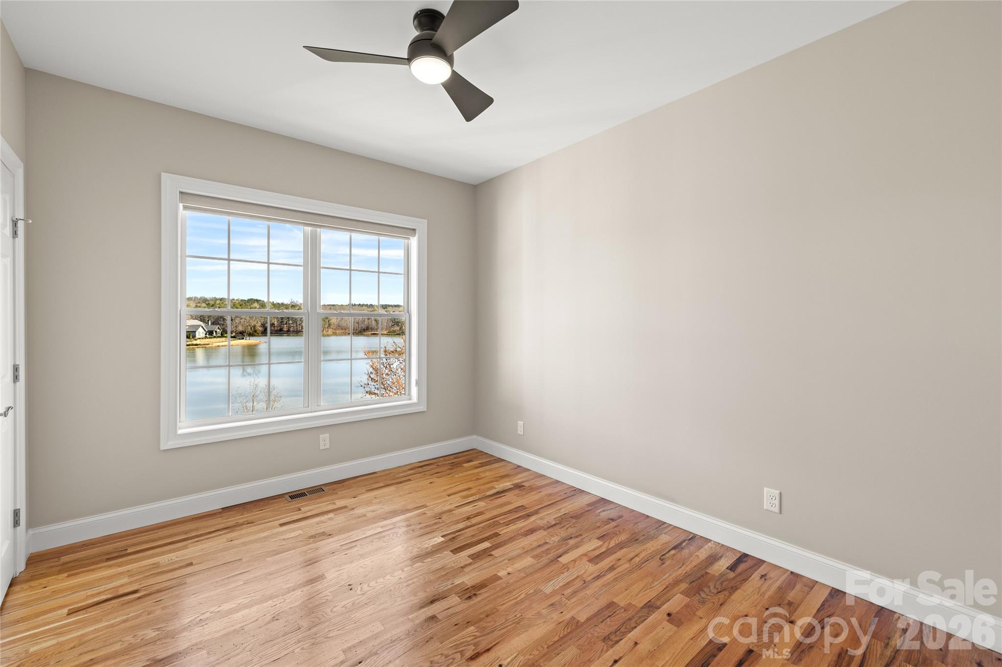 490 Mapleton Lane Columbus, NC 28722 - Photo 20 of 42 a view of empty room with wooden floor and fan