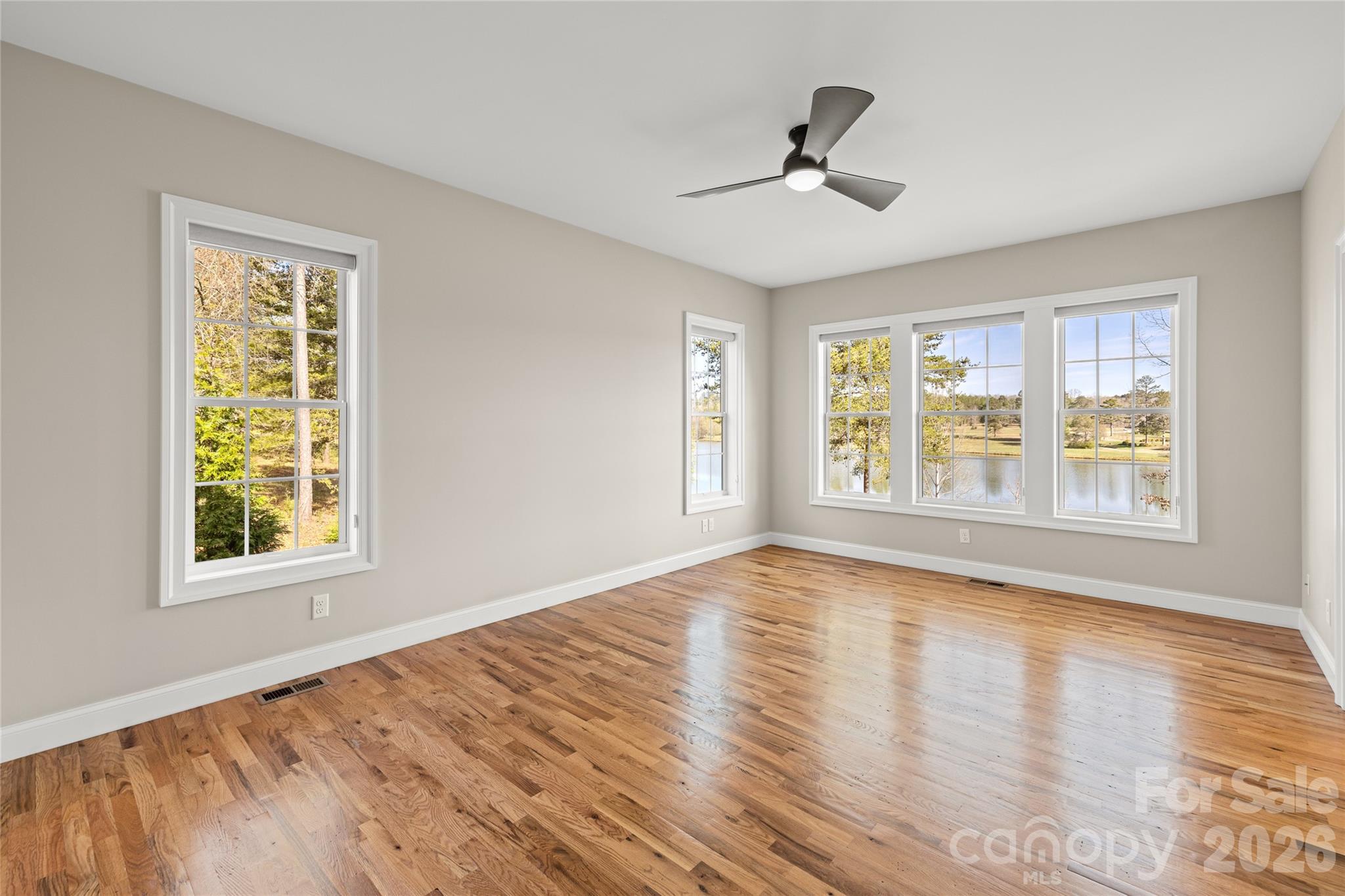 490 Mapleton Lane Columbus, NC 28722 - Photo 23 of 42 a view of an empty room with wooden floor and a window