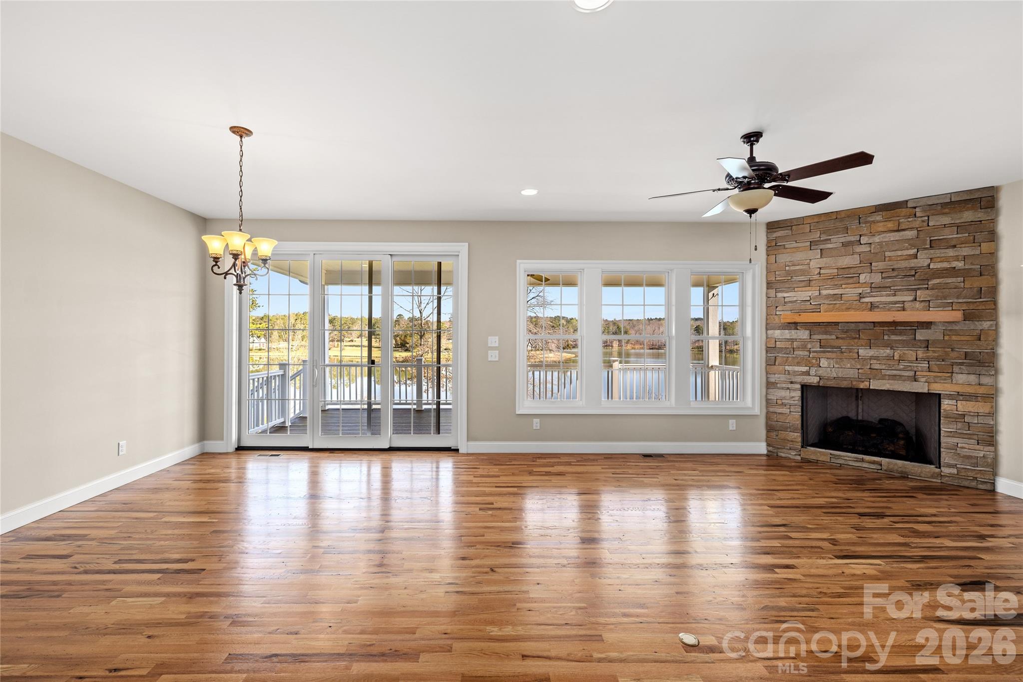 490 Mapleton Lane Columbus, NC 28722 - Photo 8 of 42 a view of an empty room with wooden floor and a fireplace