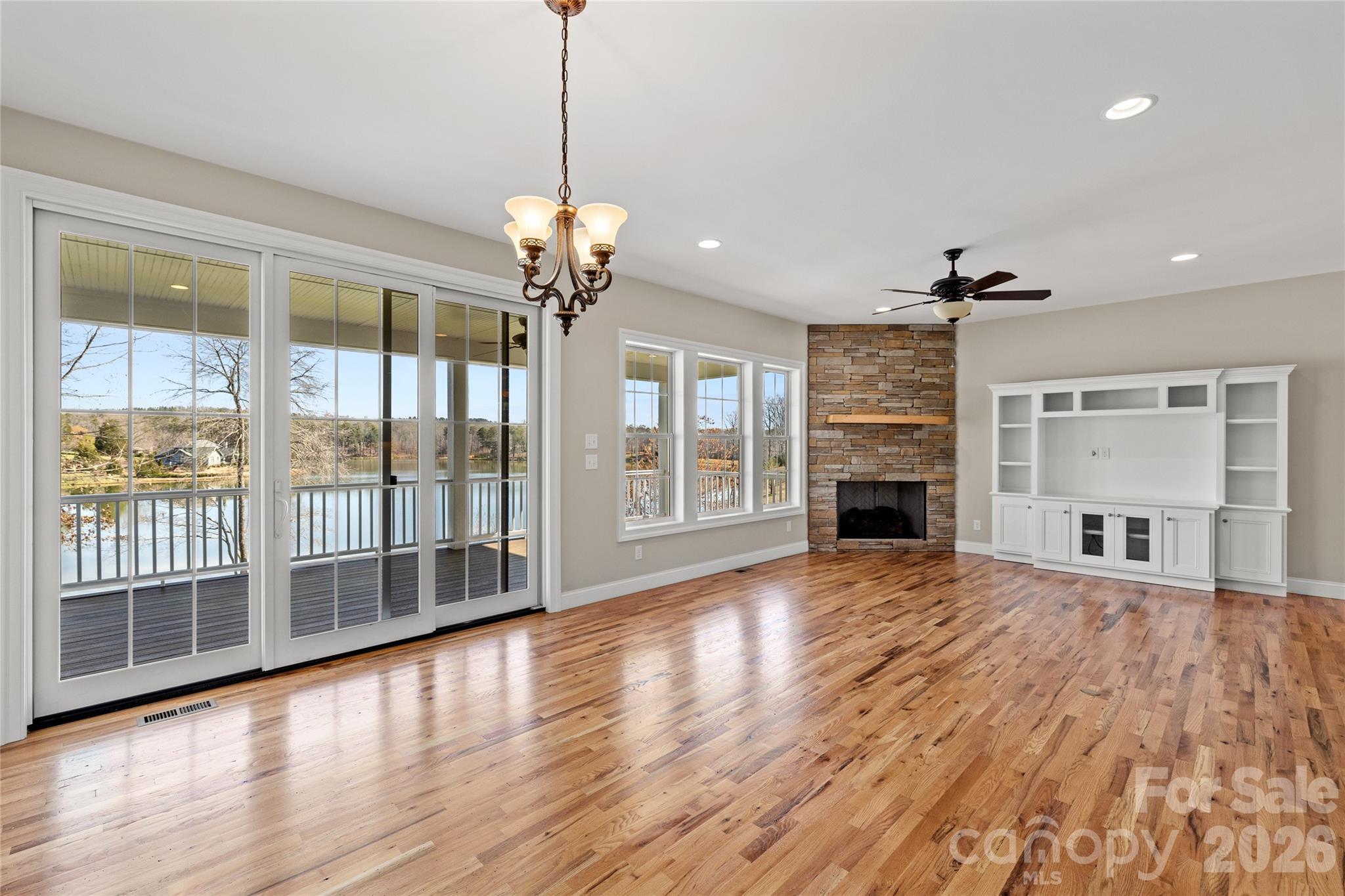 490 Mapleton Lane Columbus, NC 28722 - Photo 9 of 42 a view of a livingroom with wooden floor and a ceiling fan