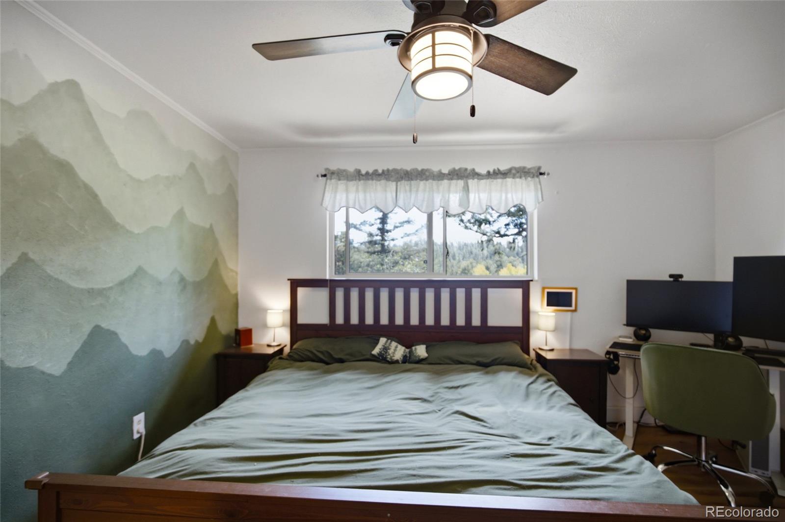 31280 Florence Road Conifer, CO 80433 - Photo 19 of 48 a bedroom with a bed window and a chandelier