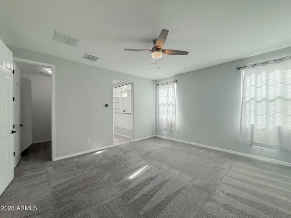 a view of an empty room with a ceiling fan
