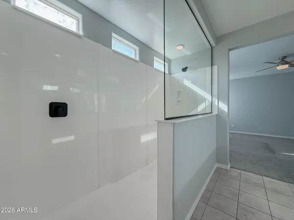 a spacious bathroom with a double vanity sink a mirror and a shower