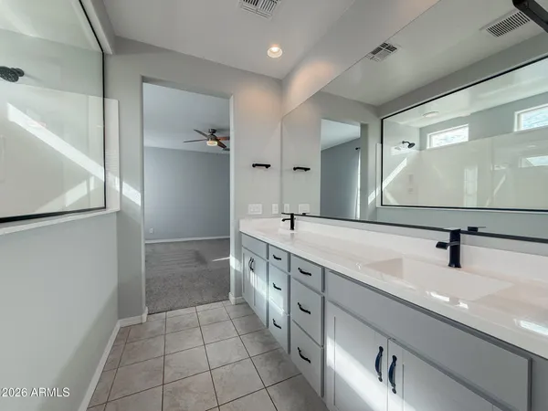 a white toilet sitting next to a white wall