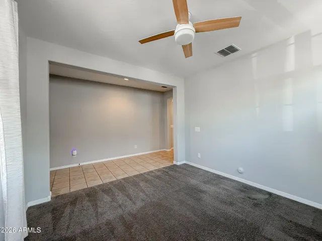 a large kitchen with granite countertop a large counter top space and stainless steel appliances