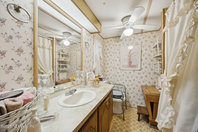 a bathroom with a sink vanity granite and toilet