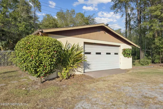a view of a house with a yard and garage