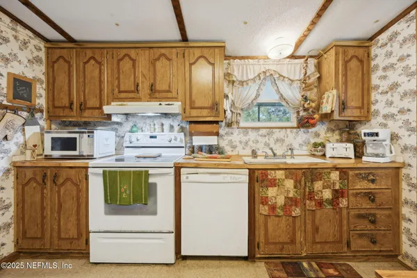 a kitchen with stainless steel appliances granite countertop a stove and a refrigerator