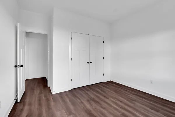 a view of room with wooden floor